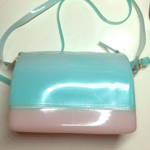 A teal and pink shoulder bag.